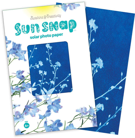 Sun Snap solar photo paper with blue floral design on packaging and paper.