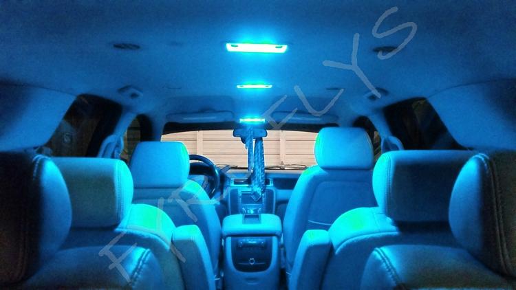 Car interior with blue LED lights illuminating the dashboard and seats.