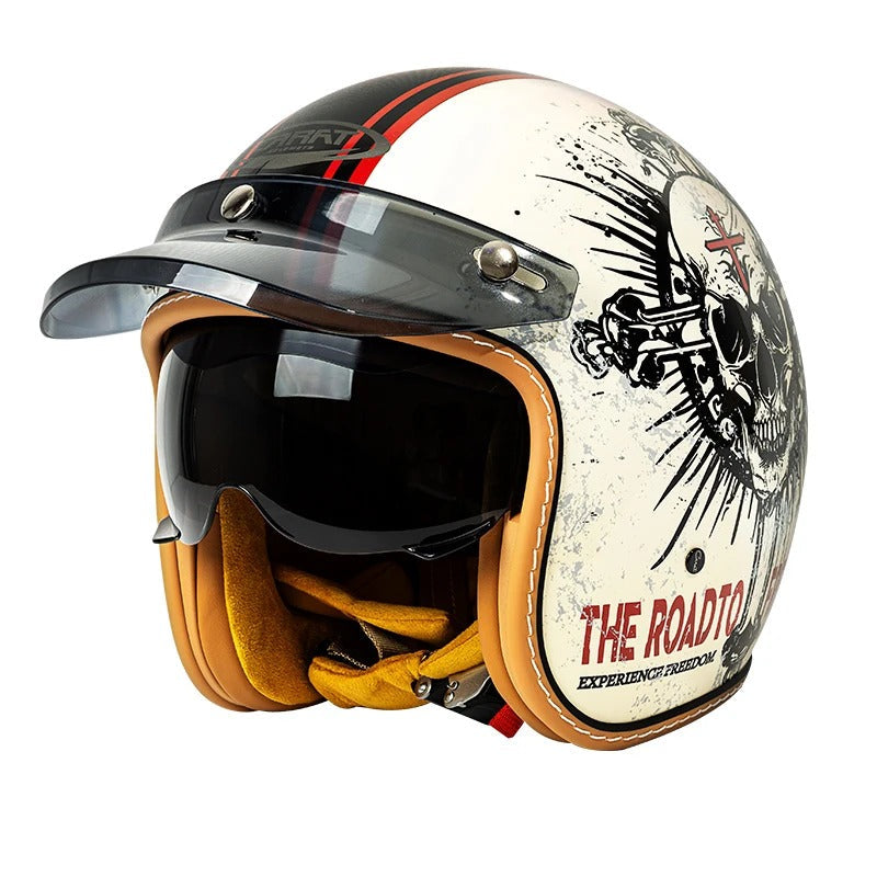 Motorcycle helmet with skull design and 'The Road to' text on a white background