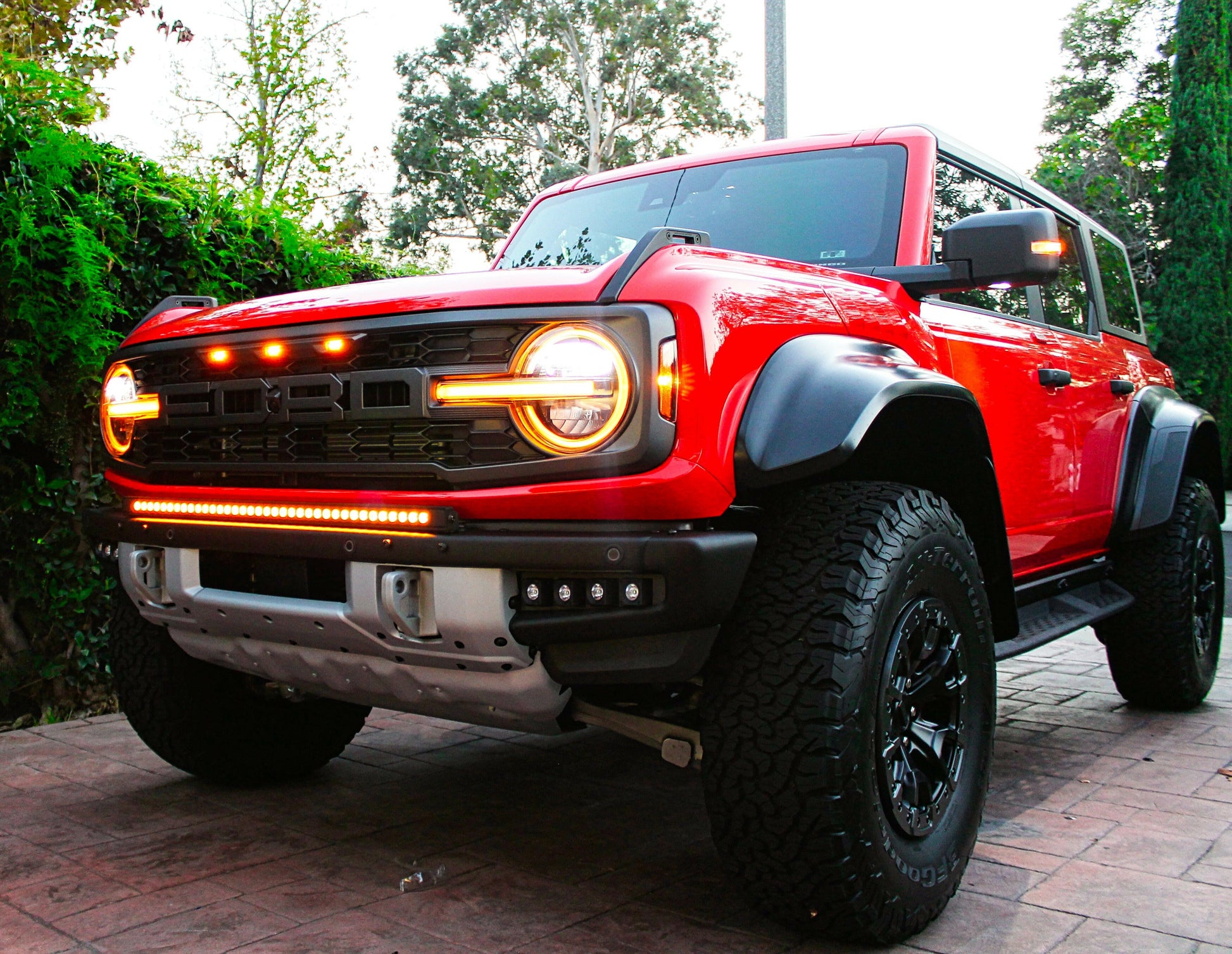 Red off-road vehicle with visible branding on a paved surface.