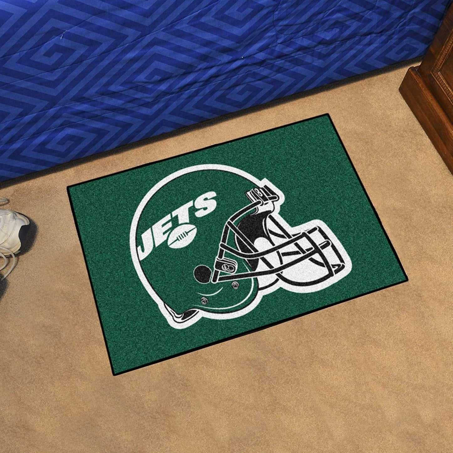 Green doormat with Jets logo on a beige floor
