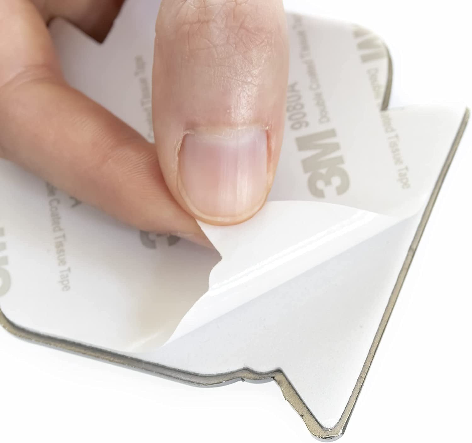 Hand peeling a strip of 3M tape from a sheet