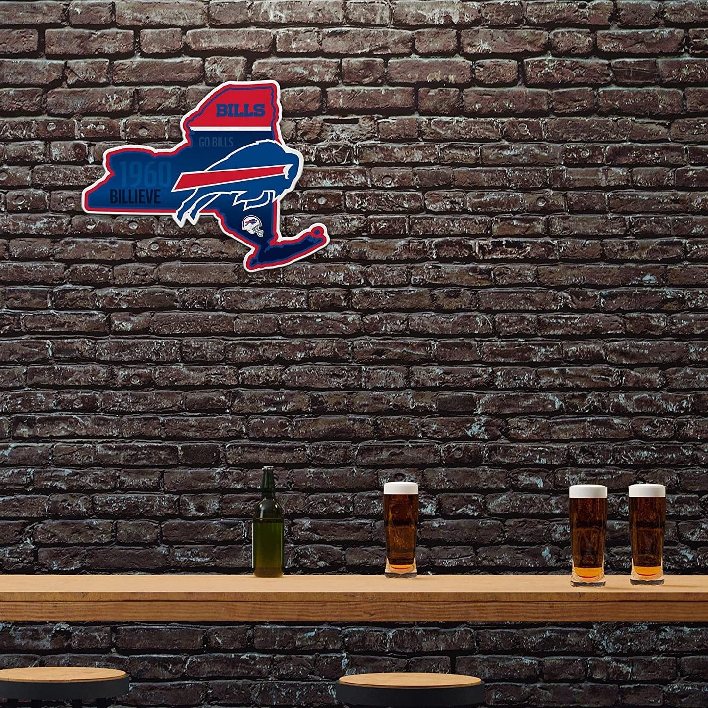 Buffalo Bills logo on a brick wall with beer glasses and a bottle on a bar counter.
