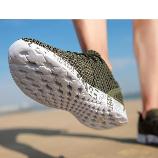 Close-up of a green athletic shoe with white sole on a blurred natural background