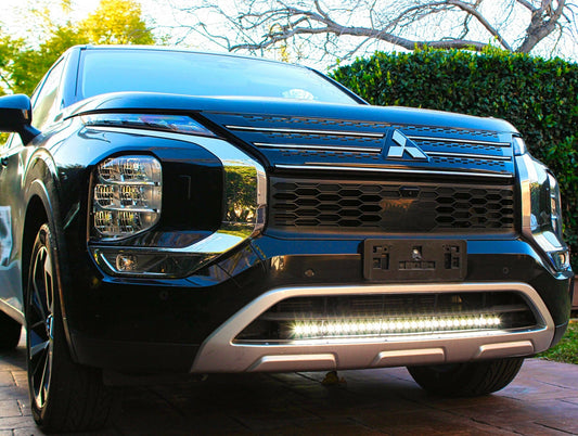 Front view of a black Mitsubishi truck with LED Light Bar on front
