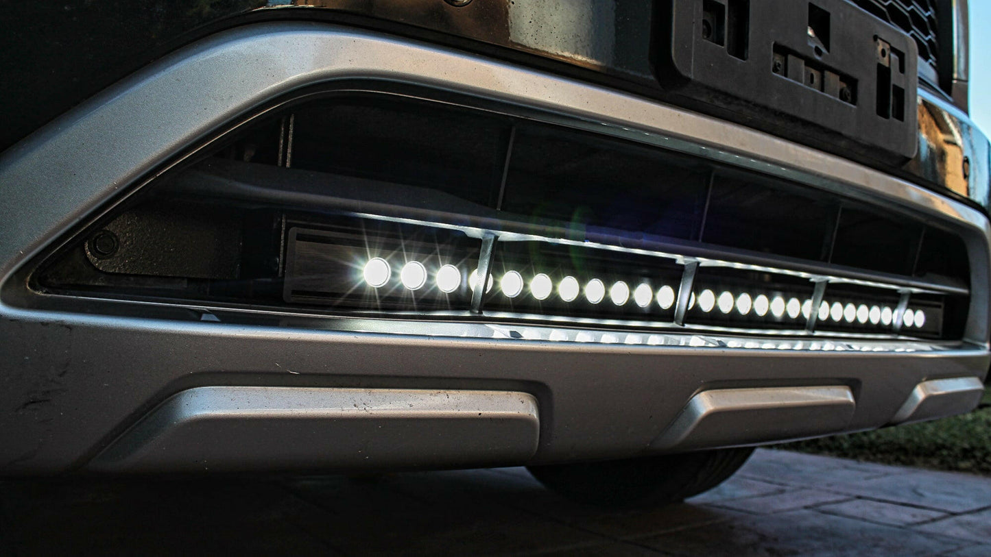 Close-up of a car's front grille with LED lights on a dark background