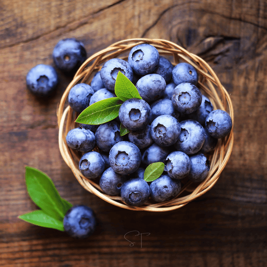 Wicker basket filled with blueberries on a wooden surface
