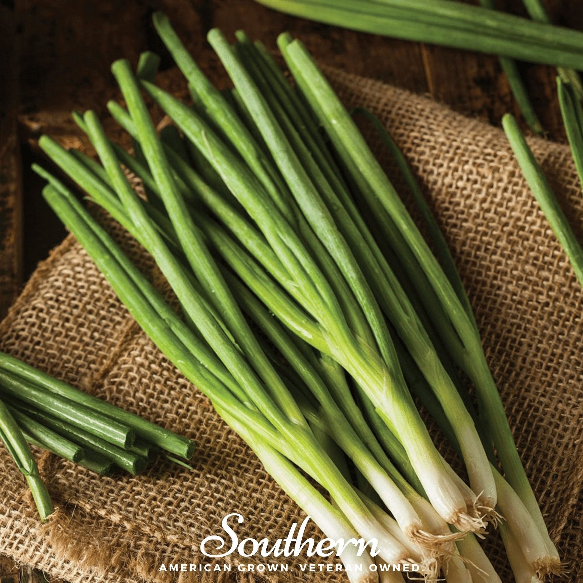 Bunch of green onions on a rustic wooden surface with 'Southern' branding.