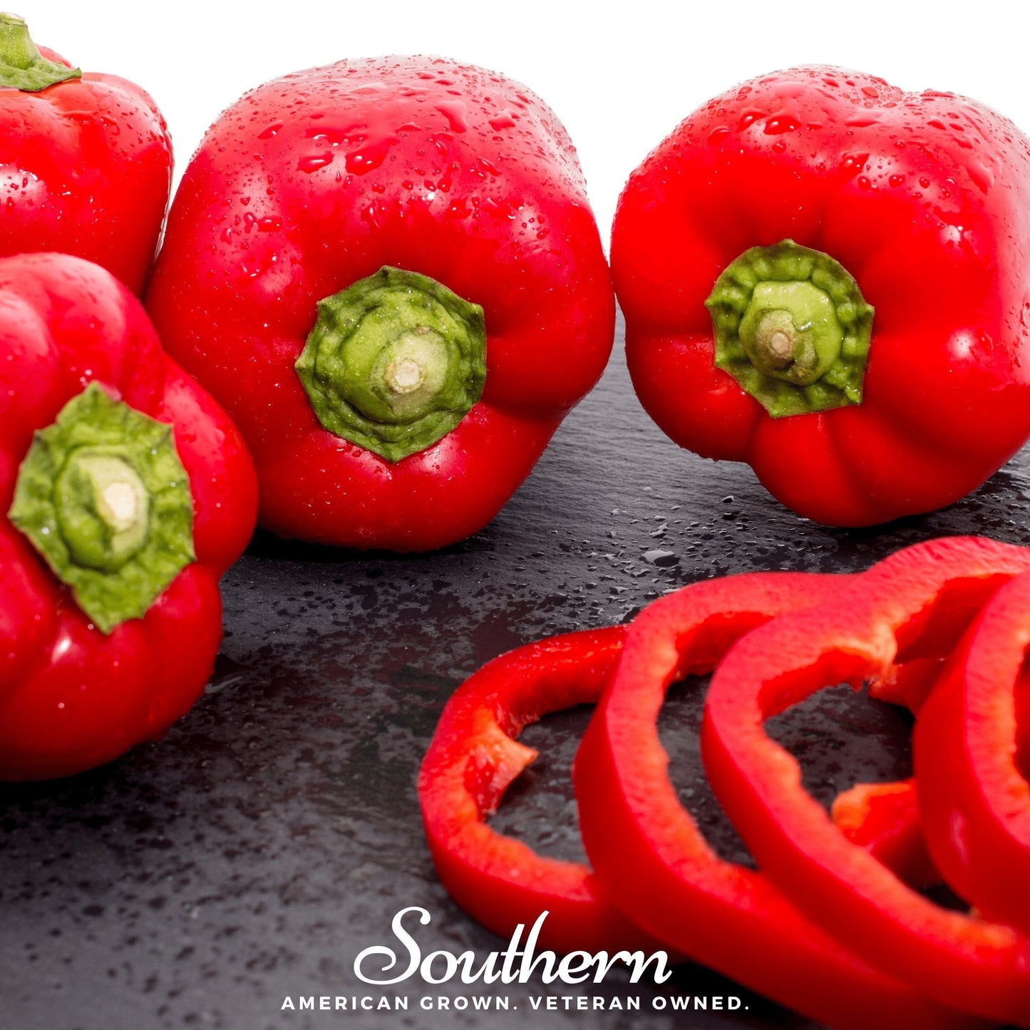 Red bell peppers with water droplets on a dark surface, branded 'Southern'.