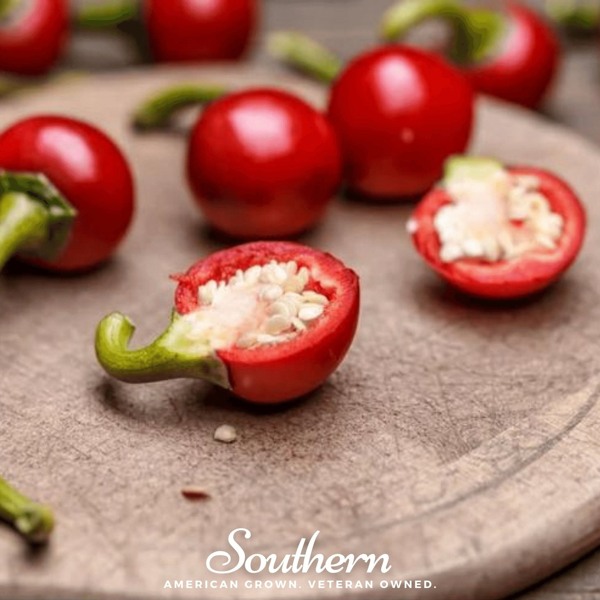Red chili peppers with seeds on a wooden surface, branded 'Southern'.