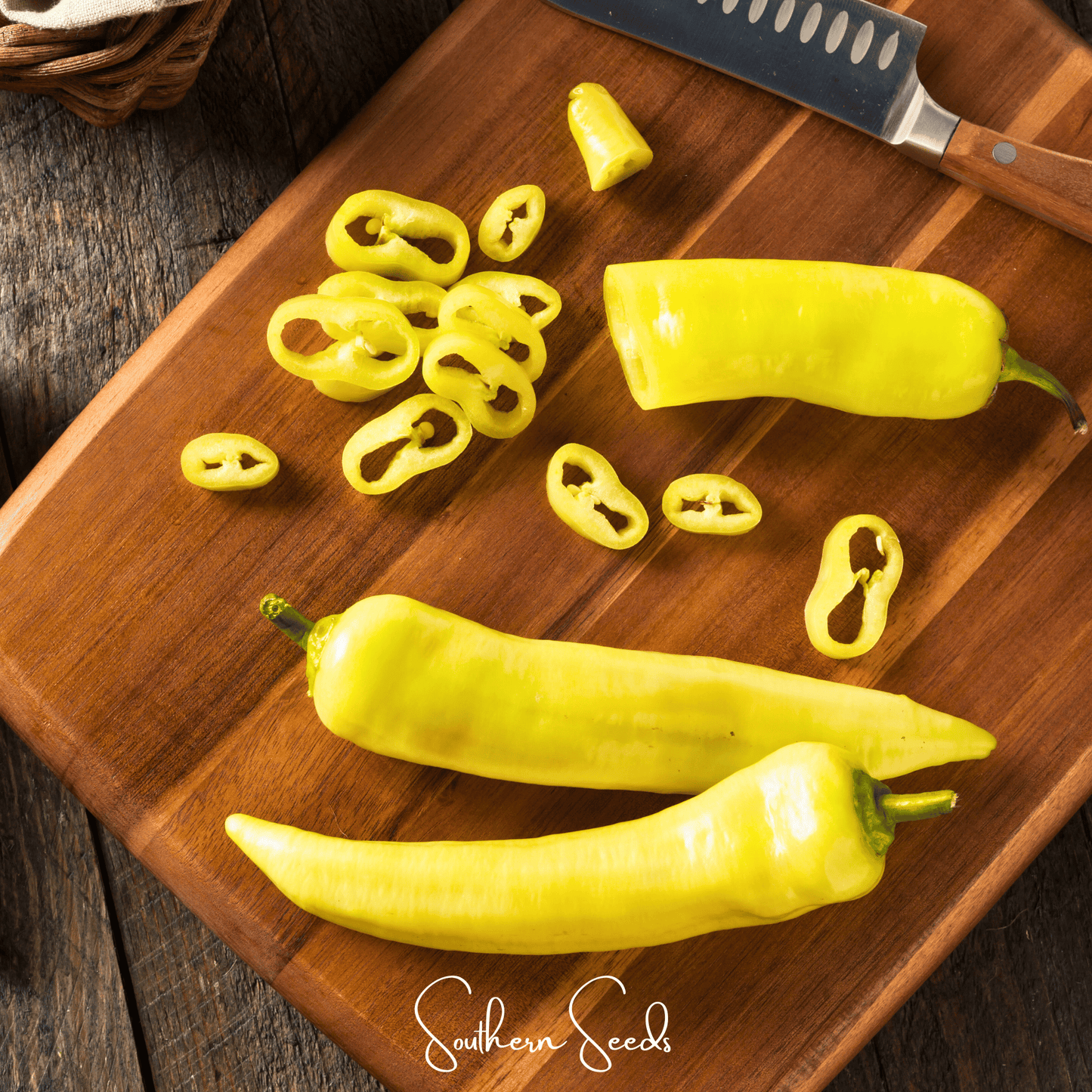 Yellow peppers on a wooden cutting board with a knife, branded 'Southern Seed'.