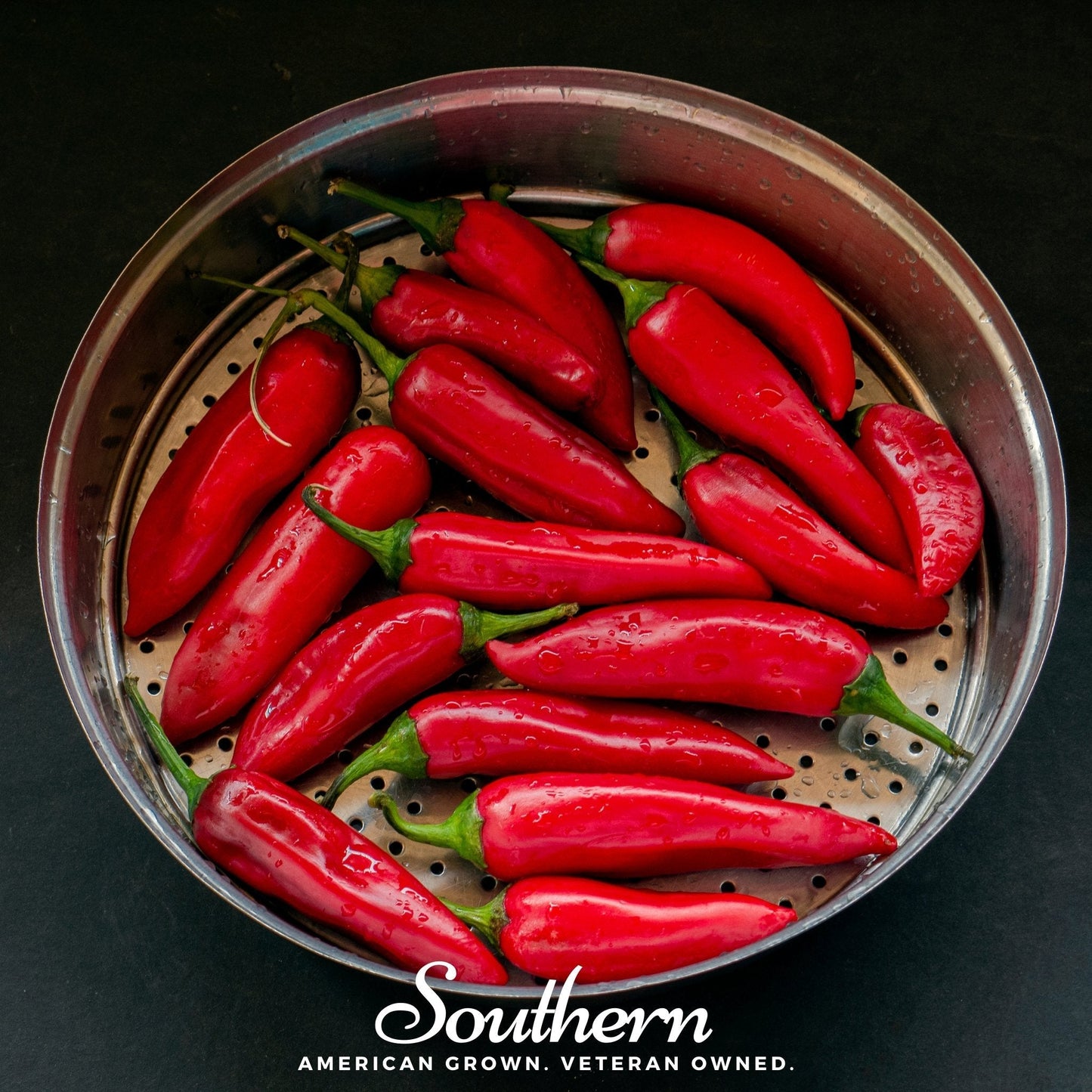 Red peppers in a metal steamer basket on a black background with 'Southern' branding.