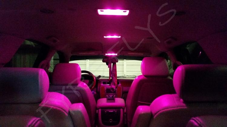 Car interior with pink LED lights and 'FYRE FLY' branding.