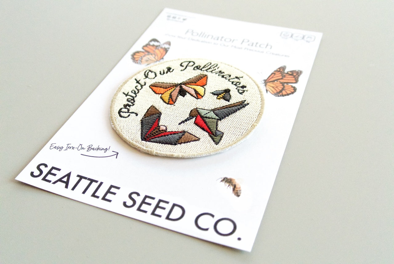 Embroidered patch with butterfly design on Seattle Seed Co. packaging