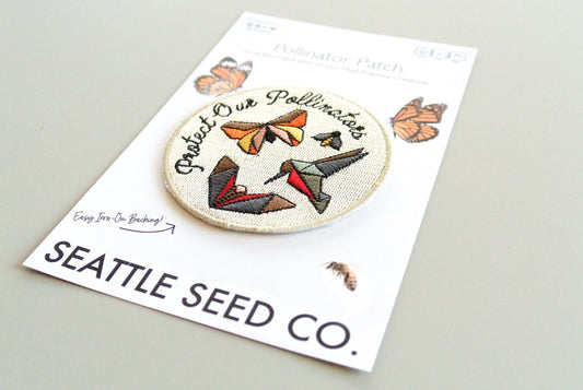 Embroidered patch with butterfly design on Seattle Seed Co. packaging