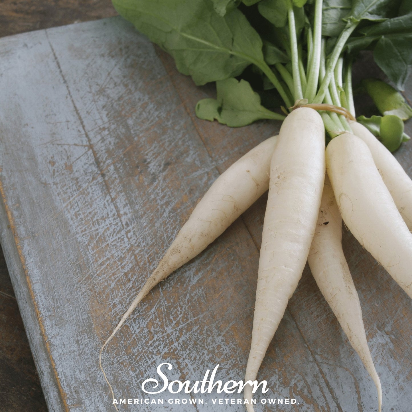 Bunch of white radishes on a wooden surface with 'Southern' branding.