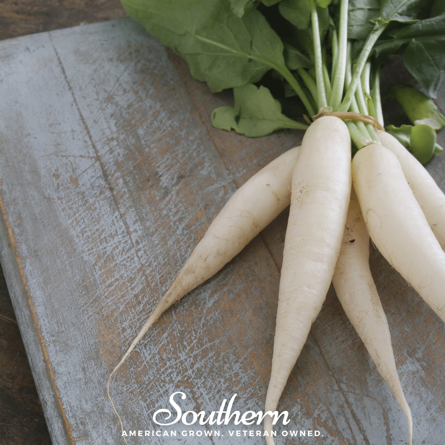 Bunch of white radishes on a wooden surface with 'Southern' branding.