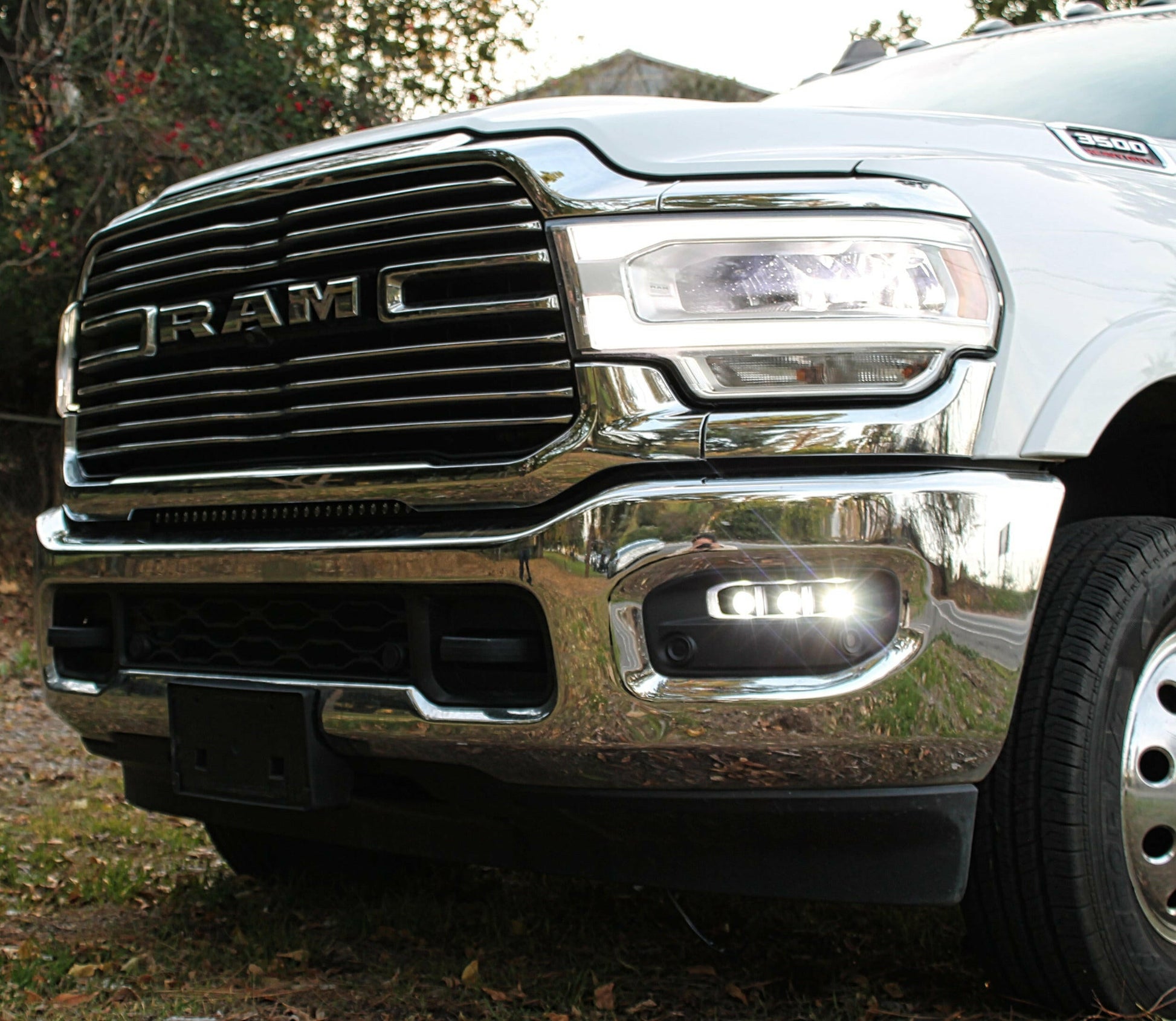 Close-up of a Ram truck's front grille and headlight.
