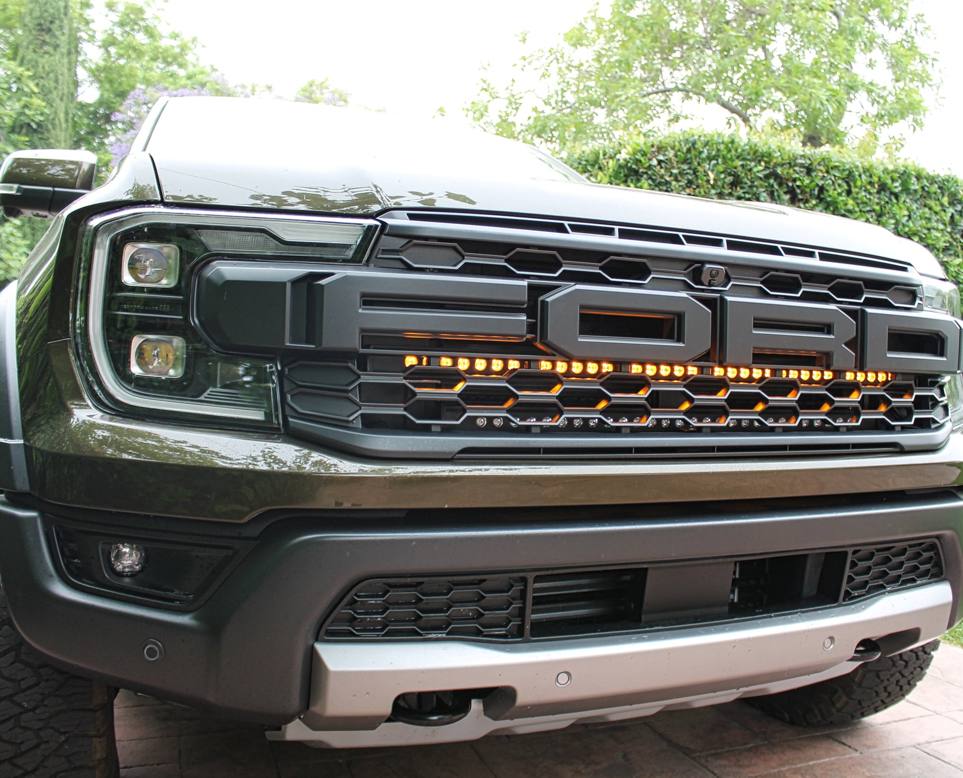 Front view of a Ford truck with illuminated grille