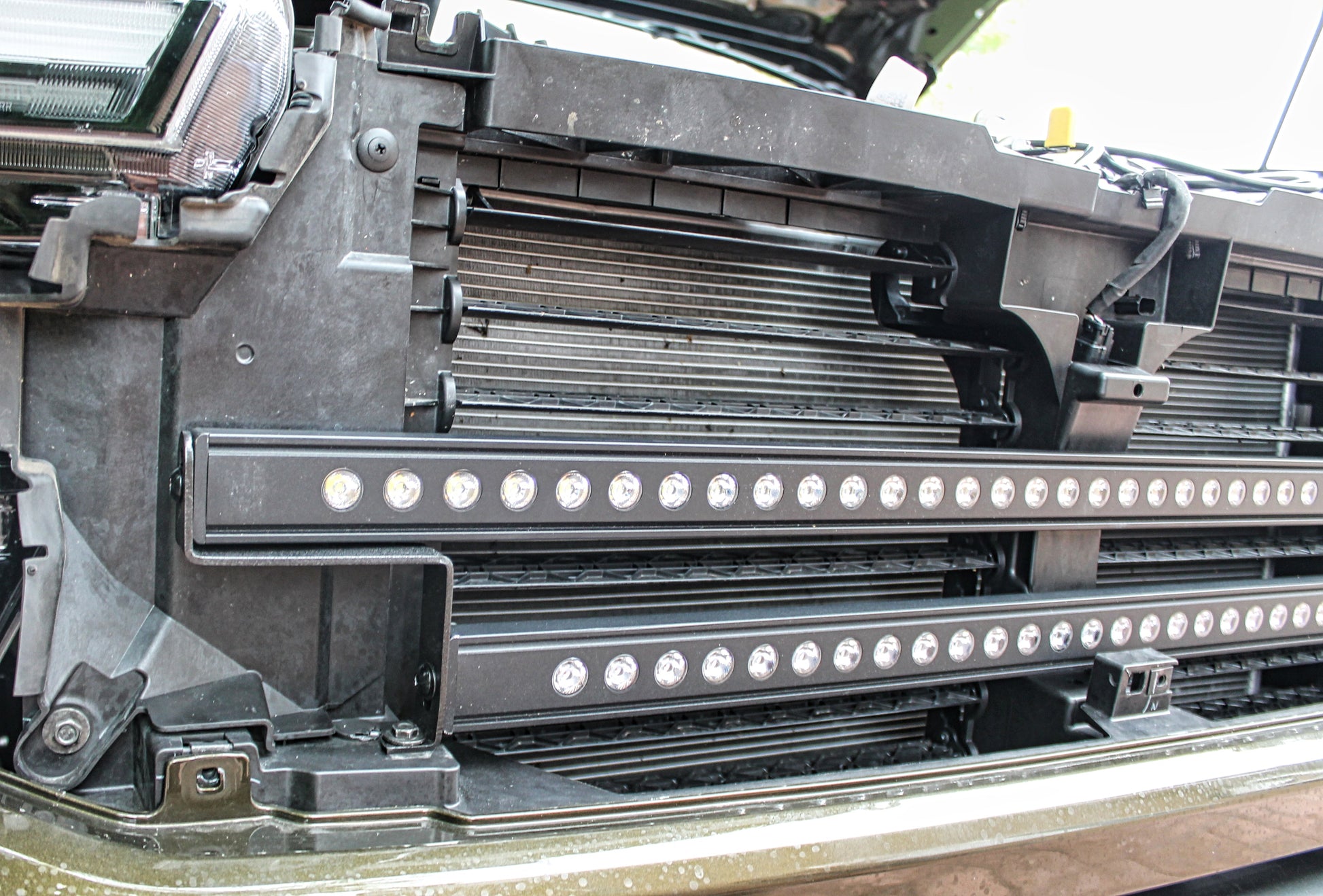 Close-up of a vehicle's undercarriage with a light bar attached