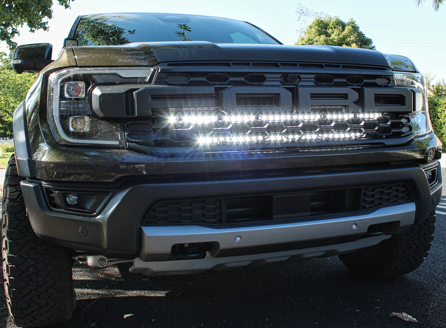 Front view of a black Ford truck with LED light bar