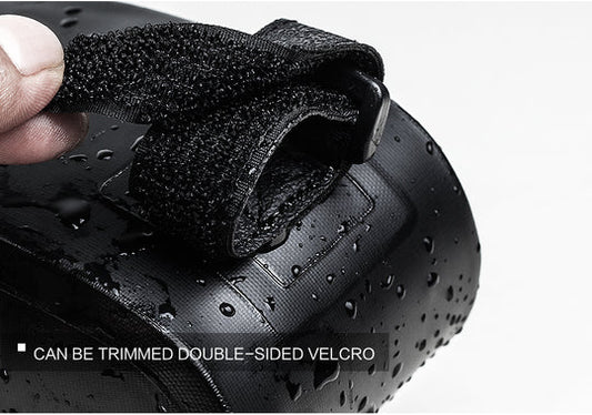 Close-up of a black bicycle bag with double-sided velcro, showing water droplets on the surface.