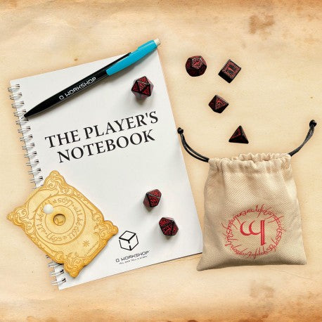 The Player's Notebook with dice and a pen on a wooden surface