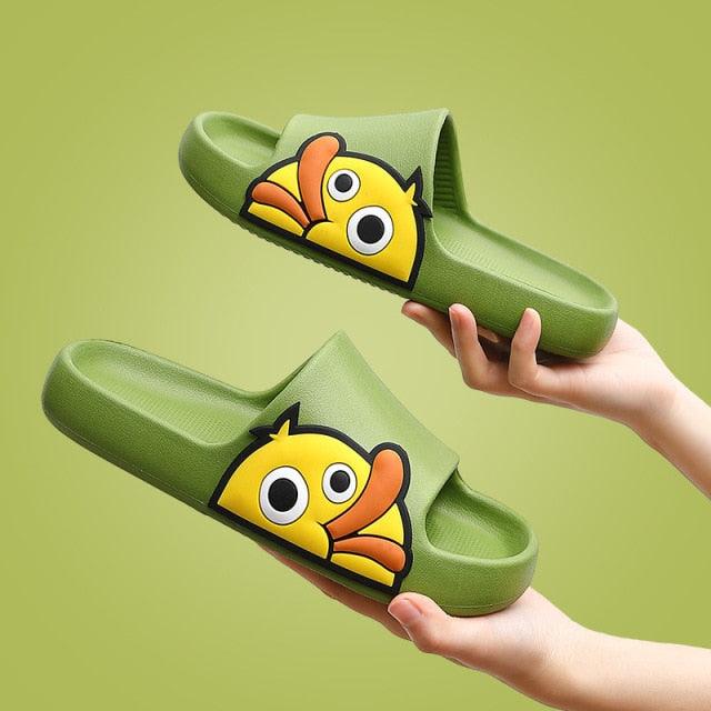 Green slides with cartoon fish design held by a hand on a green background