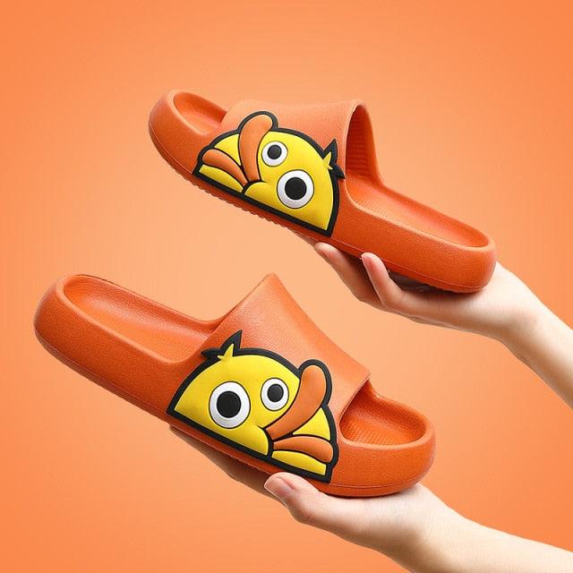 Orange slides with fish design held by hands against an orange background