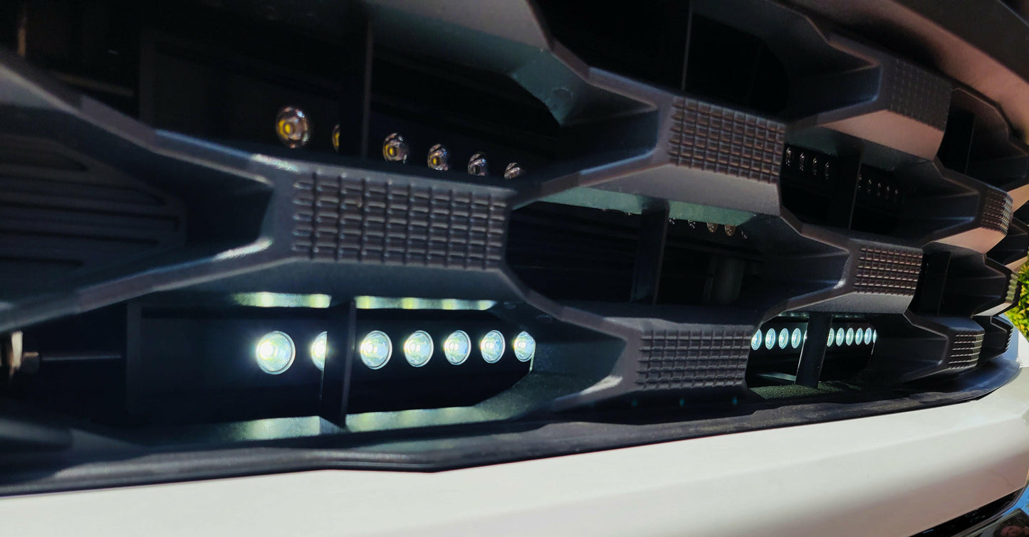 Close-up of a car grille with LED lights