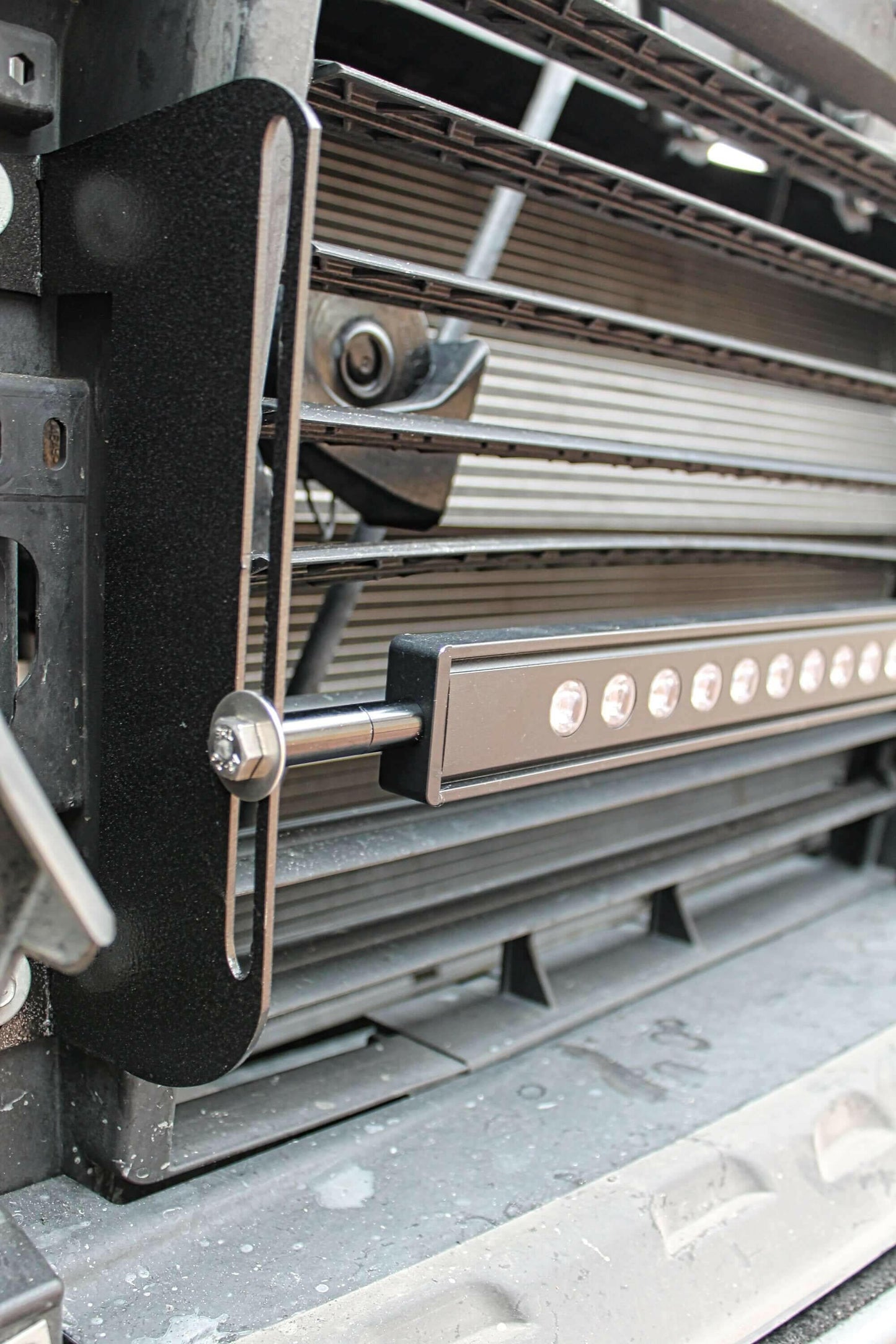 Close-up of a vehicle grille with a light bar attached