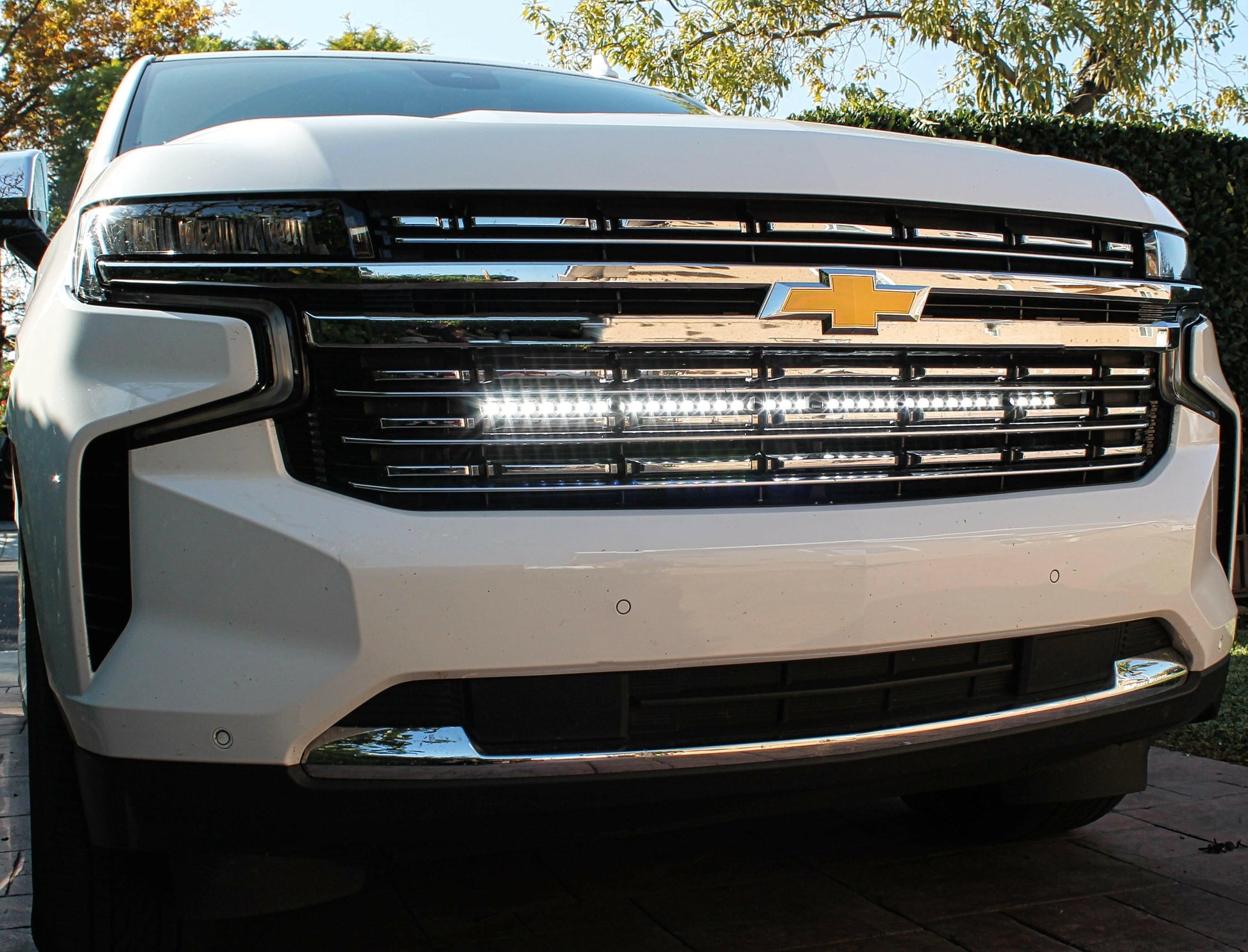 Close-up of a white Chevrolet vehicle's front grille with an LED Light Bar