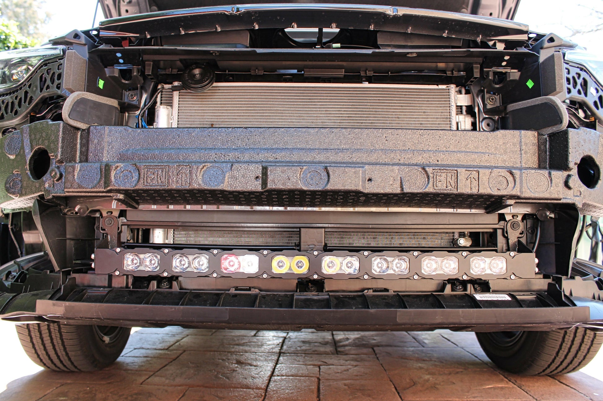 Close-up of a vehicle's undercarriage with visible components and lights.