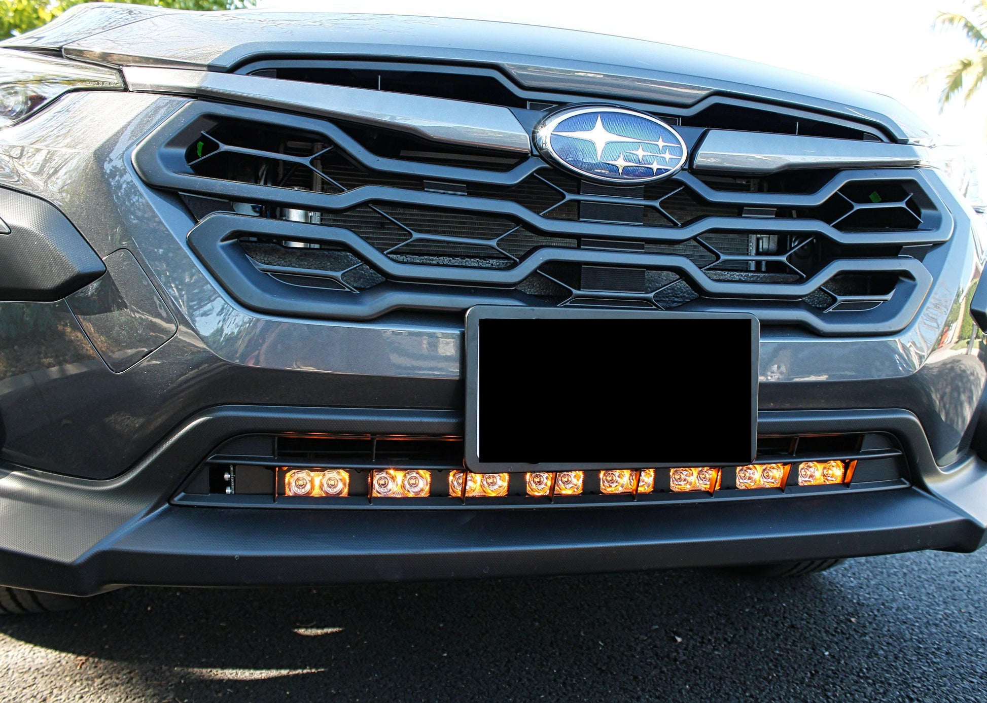Close-up of a car's front grille with visible Subaru logo