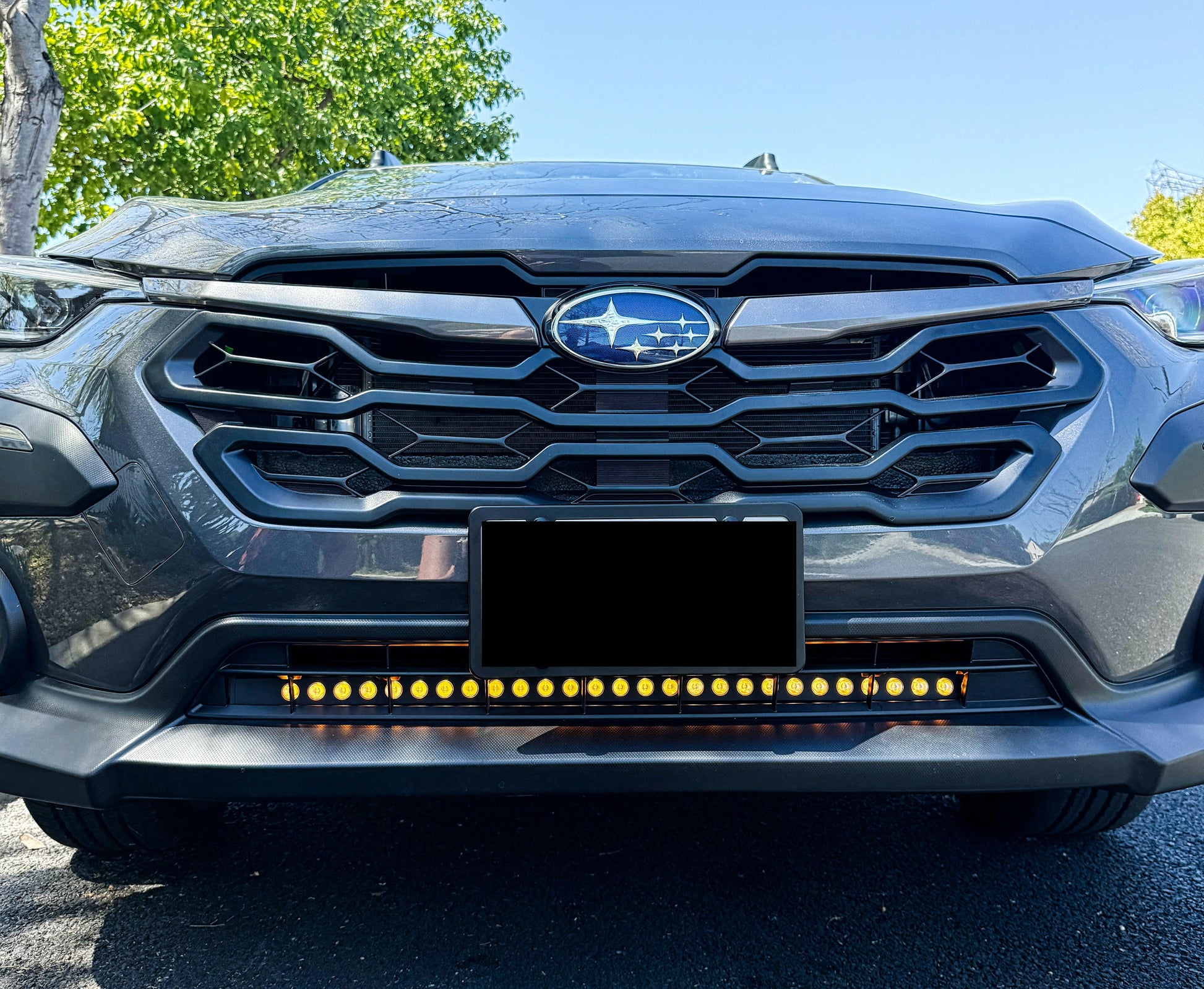 Front view of a car with LED Light Bars and a prominent grille and Subaru logo.