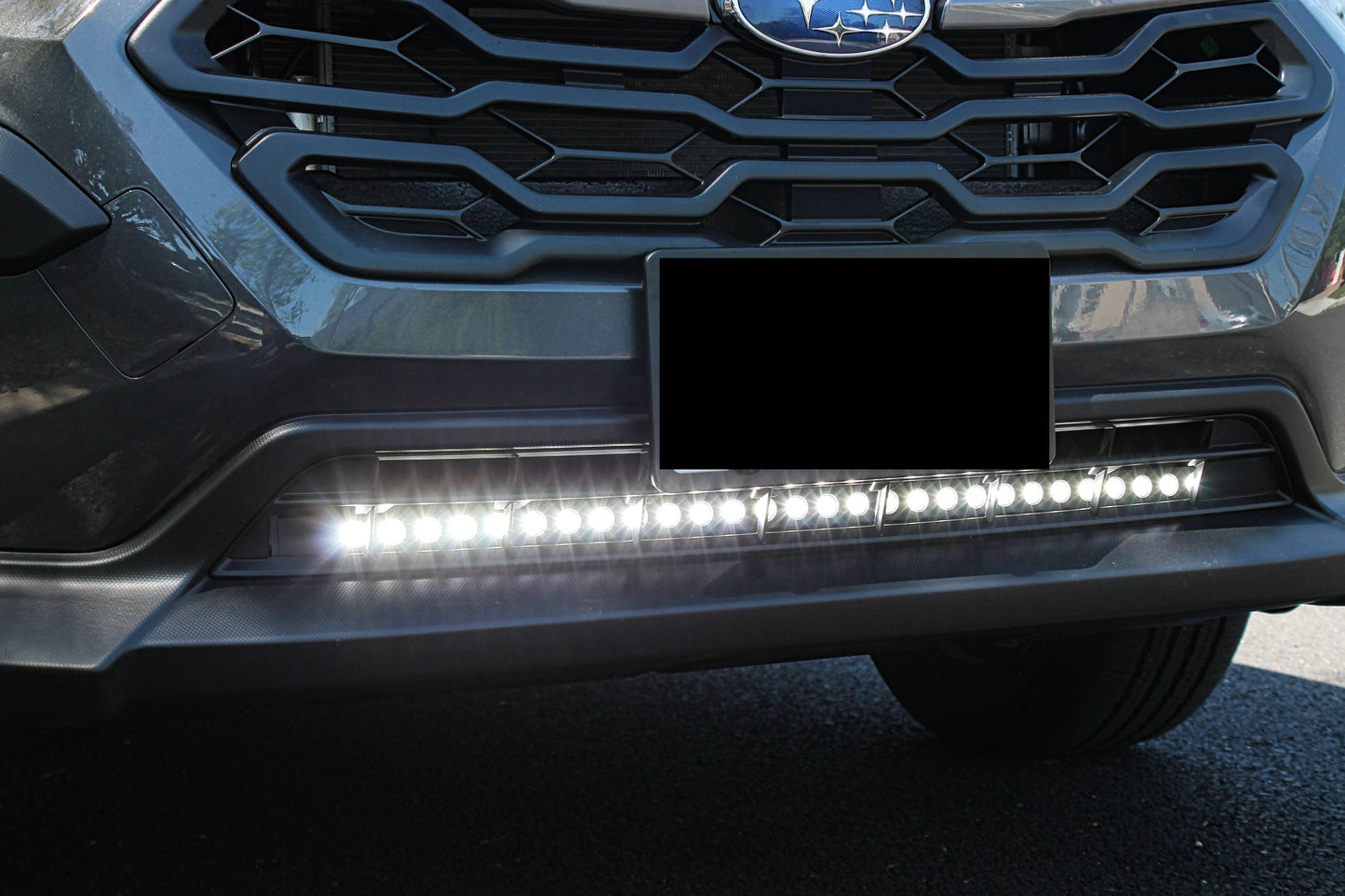 Close-up of a car's front grille with a visible brand logo and LED Light Bars