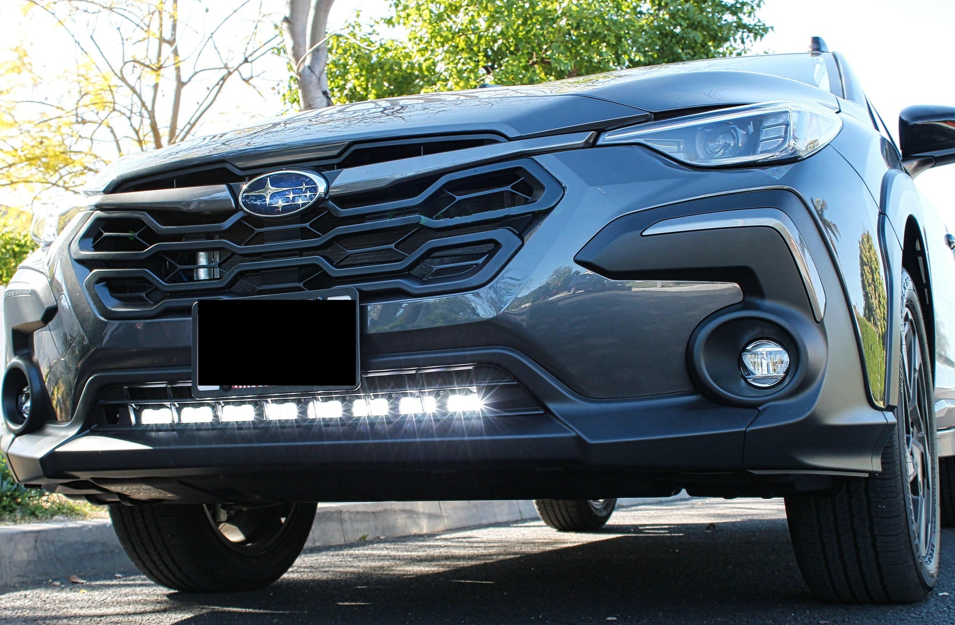 Front view of a car with LED Light Bar on a clear sky background.