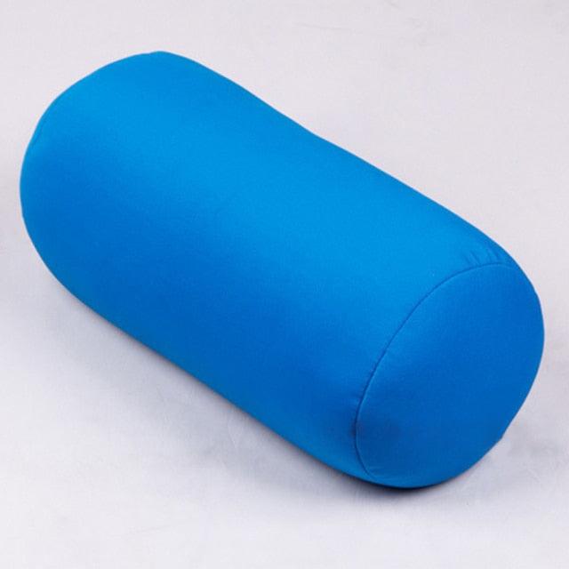 Blue cylindrical pillow on a light gray background