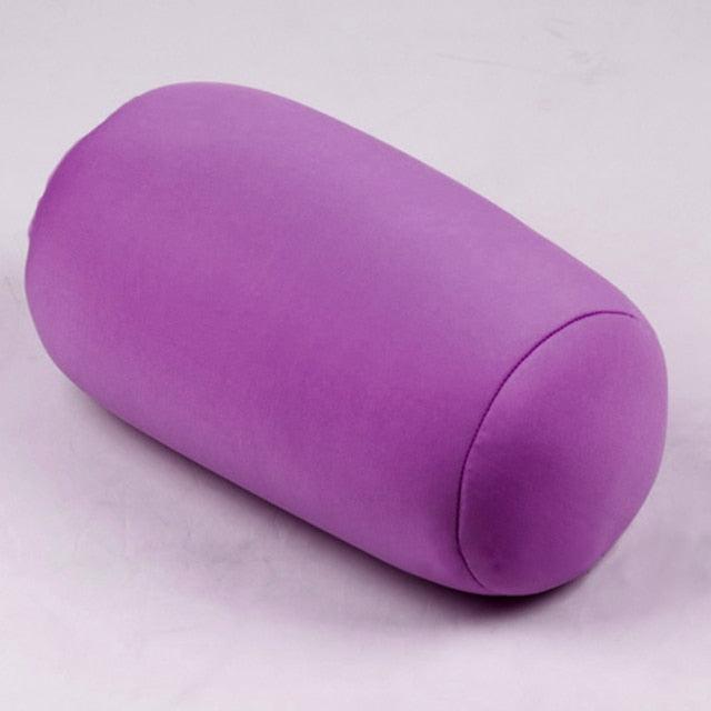 Purple cylindrical pillow on a light gray background