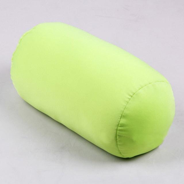 Green cylindrical pillow on a light gray background