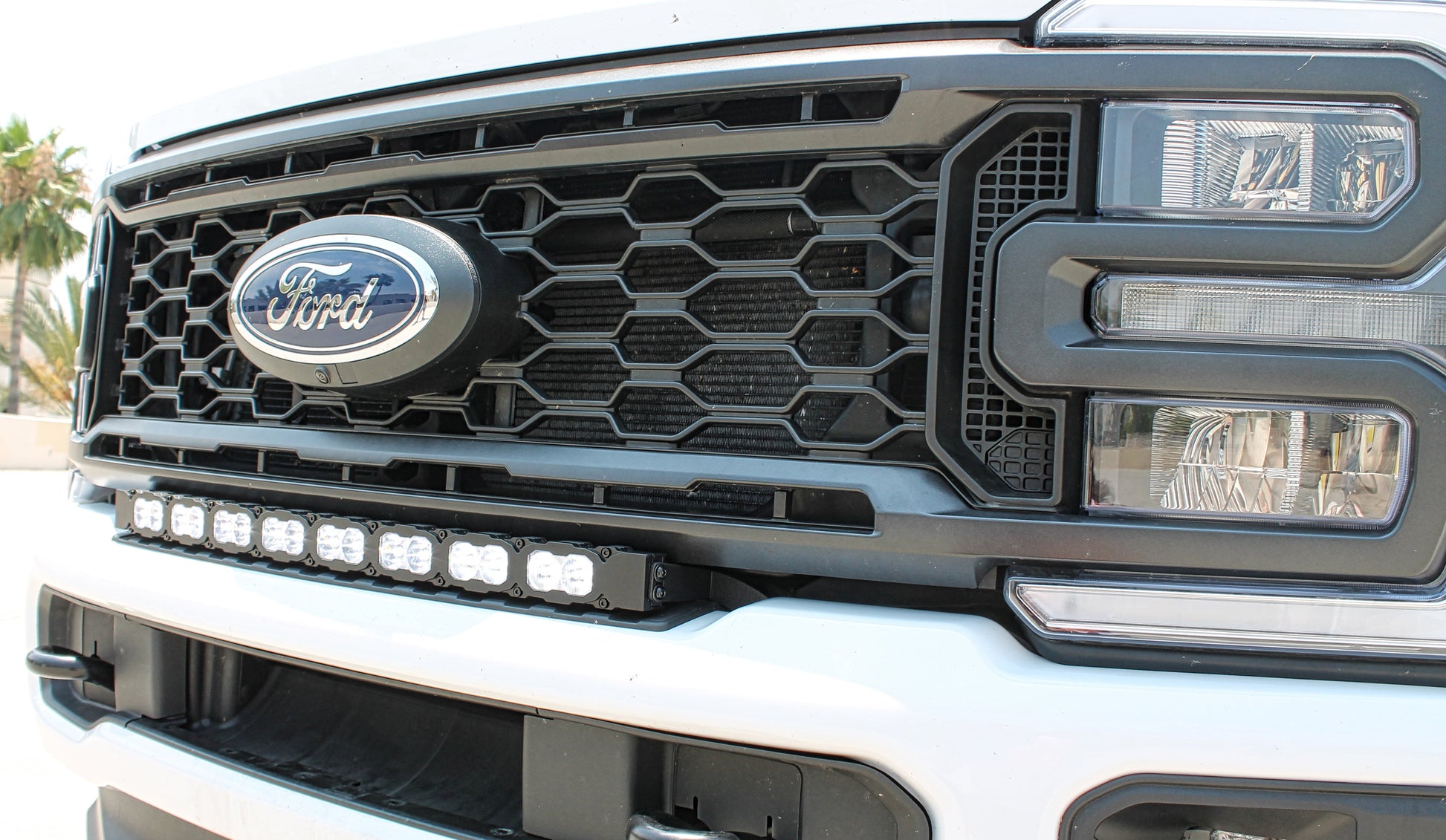 Close-up of a Ford vehicle grille with headlights and LED Light Bar.