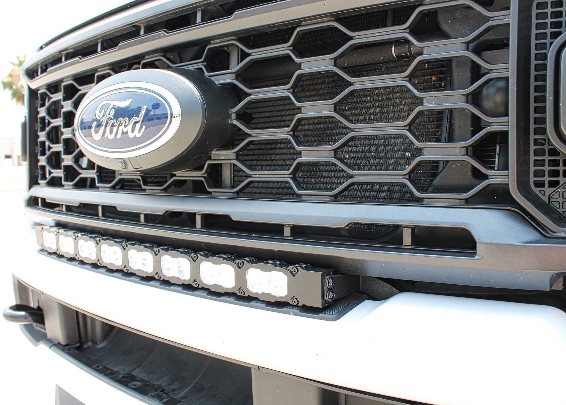 Ford vehicle grille with logo and additional lighting setup