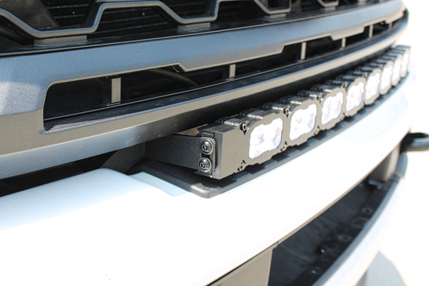Close-up of a vehicle grille with LED light bar