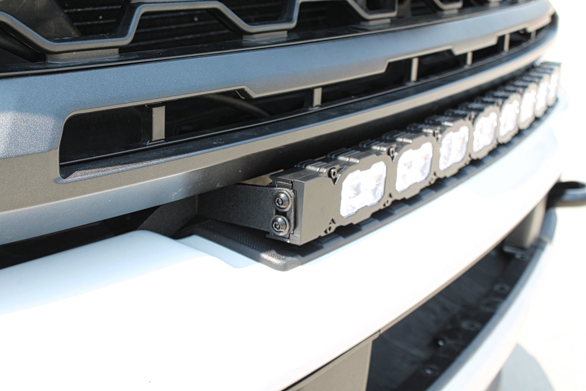 Close-up of a vehicle grille with LED light bar