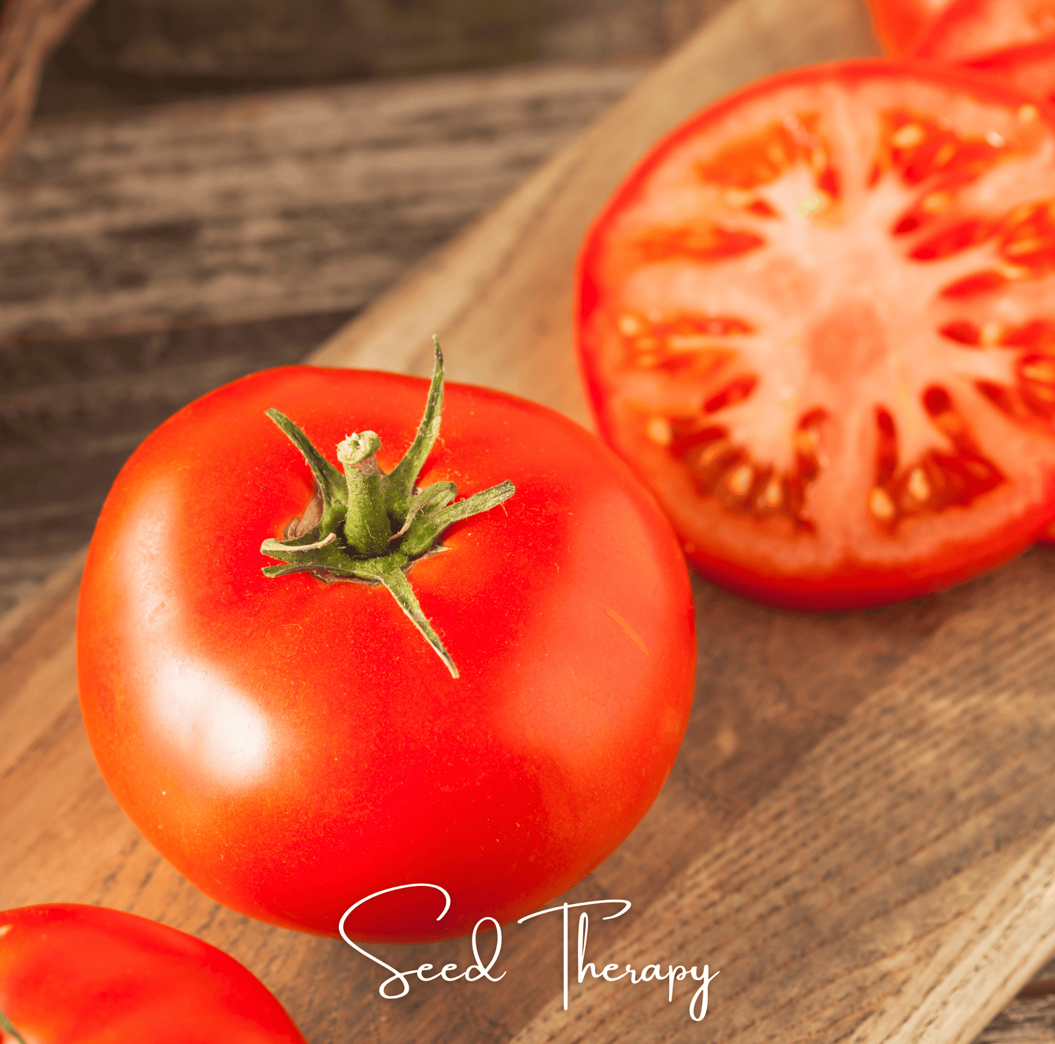 Whole and sliced red tomatoes on a wooden surface with 'Seed Therapy' branding.