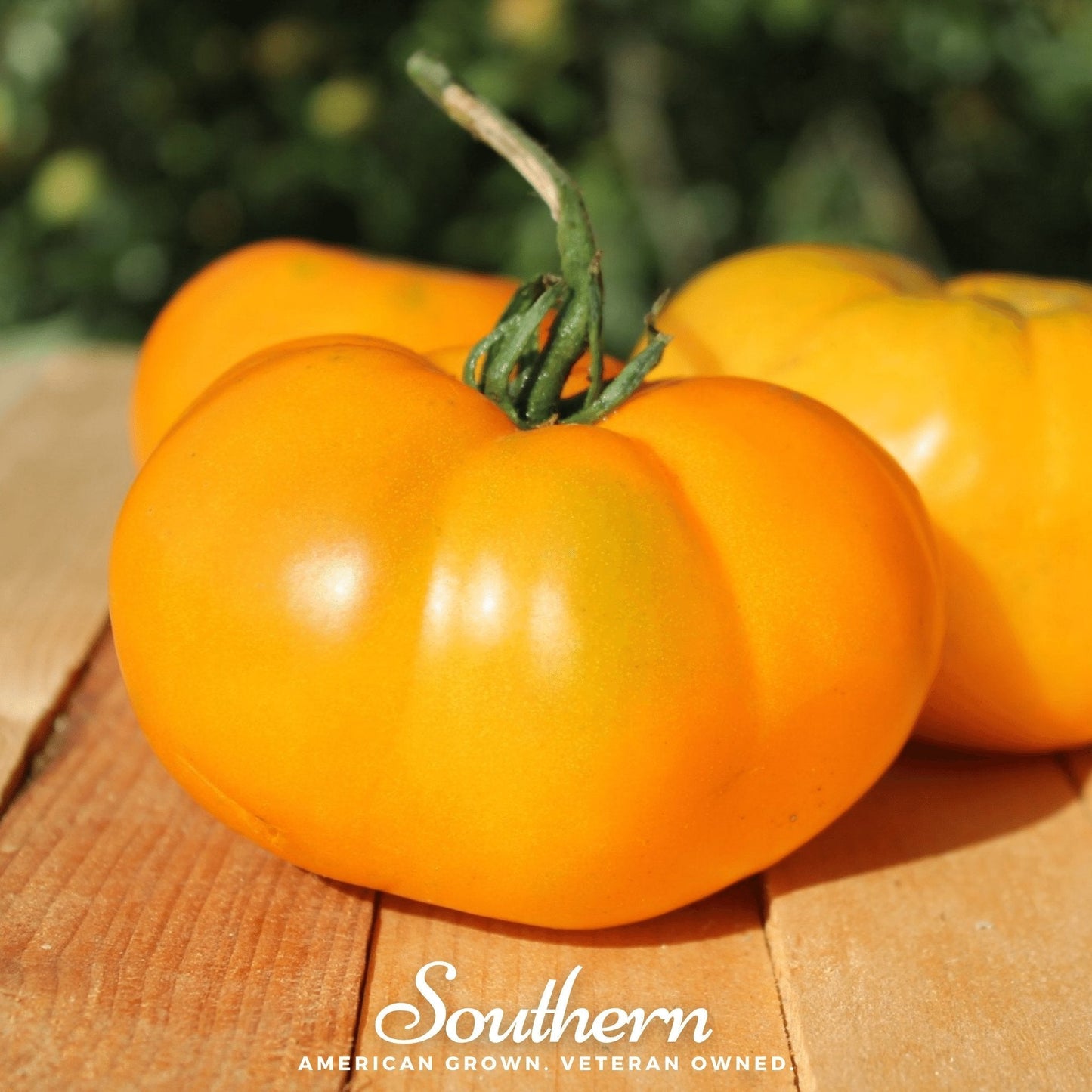 Orange tomatoes on a wooden surface with 'Southern' branding.