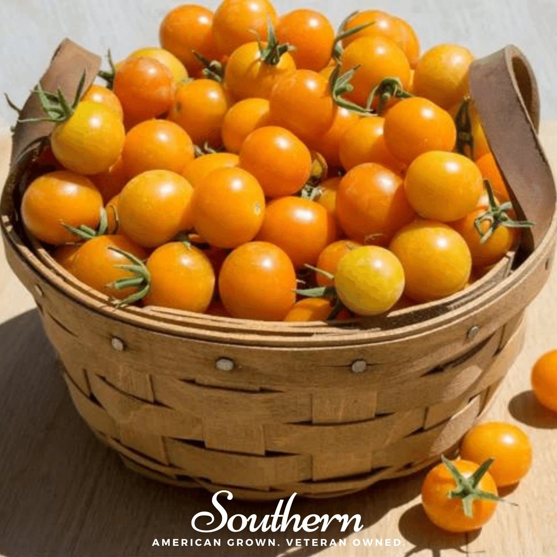 Basket of yellow cherry tomatoes with 'Southern' branding on a wooden surface.