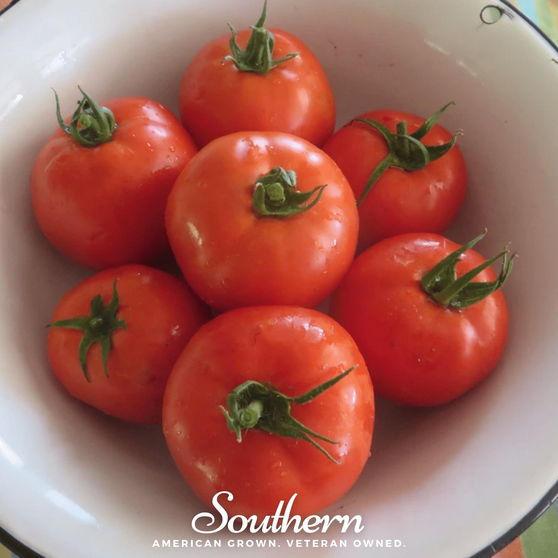 Red tomatoes with green stems in a white bowl, featuring the 'Southern' brand.