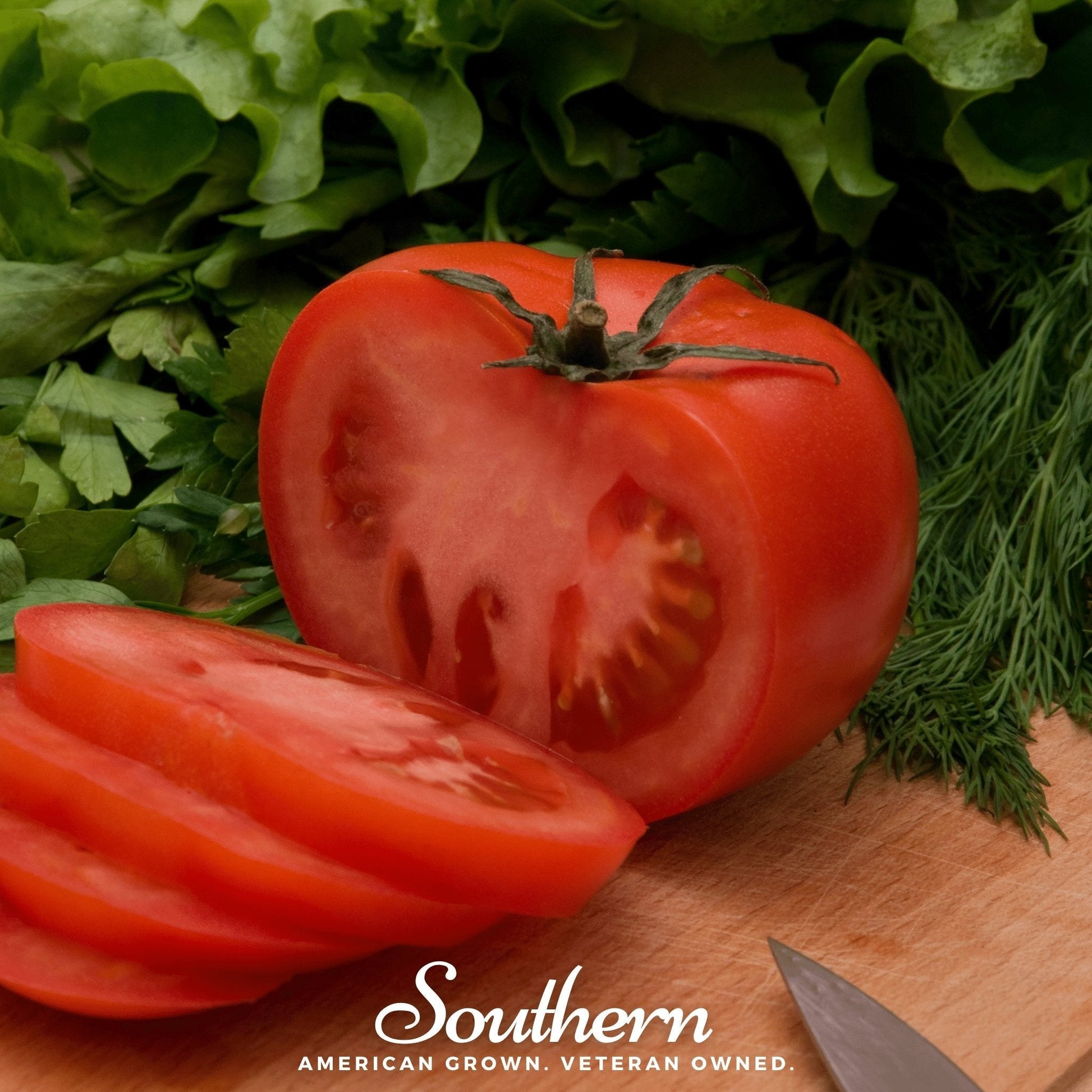 Tomatoes on a wooden cutting board with green leafy vegetables, featuring the 'Southern' brand.