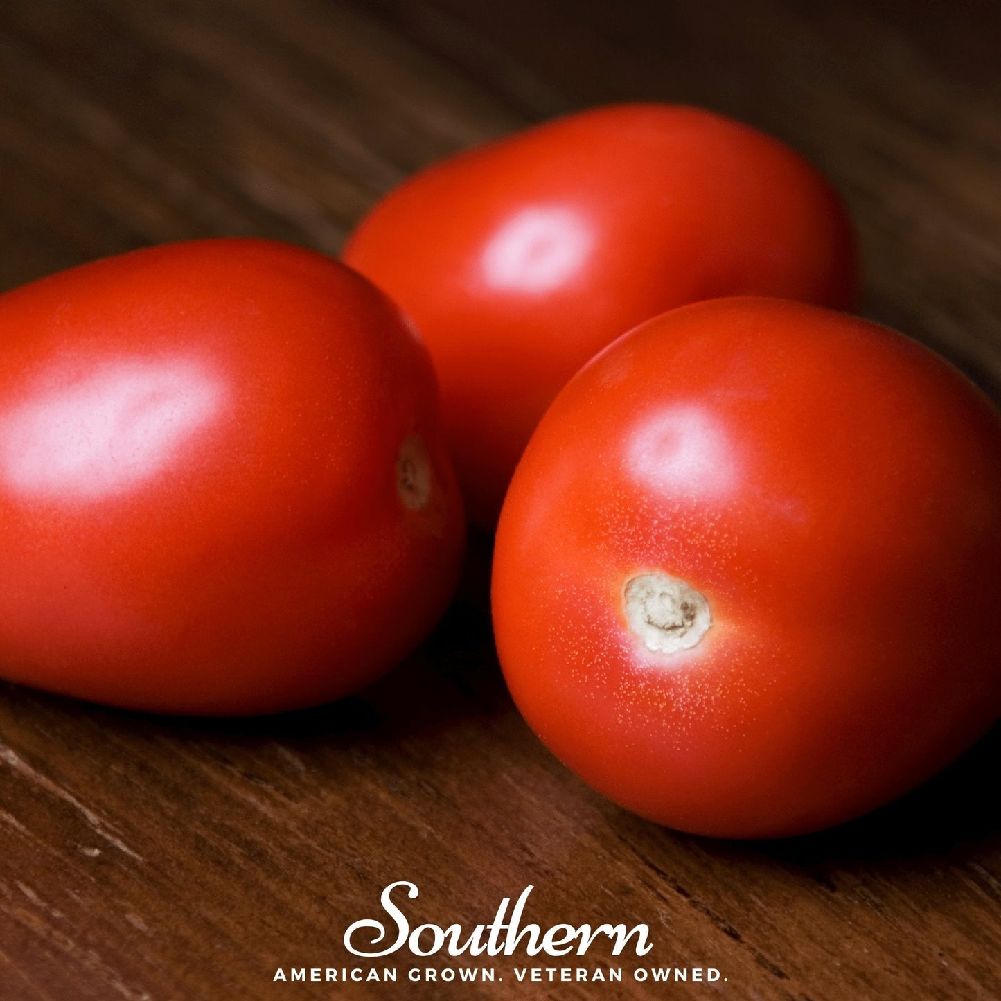 Three red tomatoes on a wooden surface with 'Southern' branding.